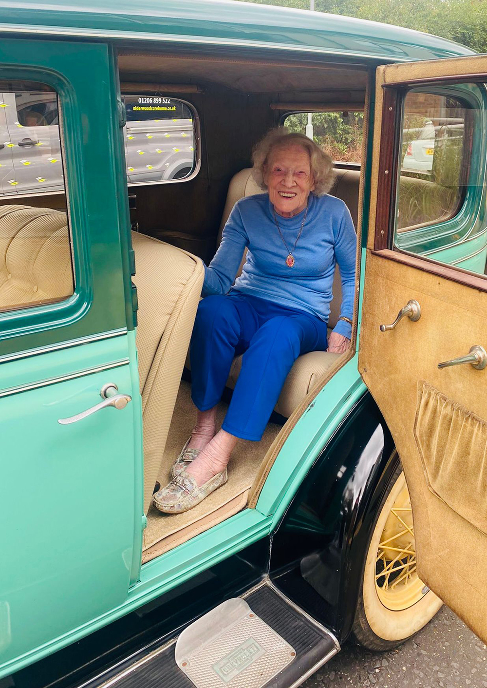Care home resident sits in vintage car